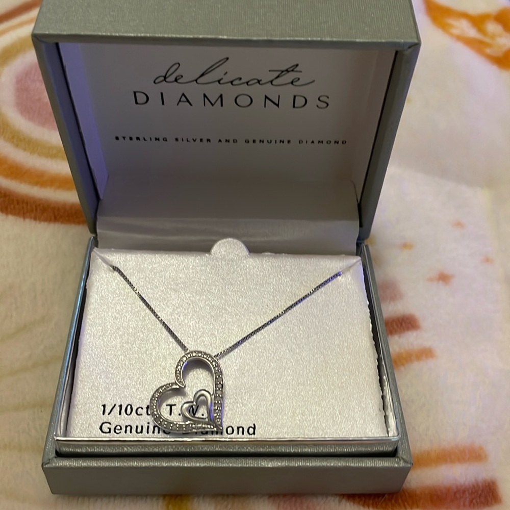 Delicate diamonds. Sterling silver pendant. 18 inch chain. 1/10 CTTW diamond.